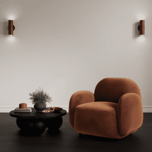 Kenji Black Coffee Table in a dark styled room with burnt orange chair